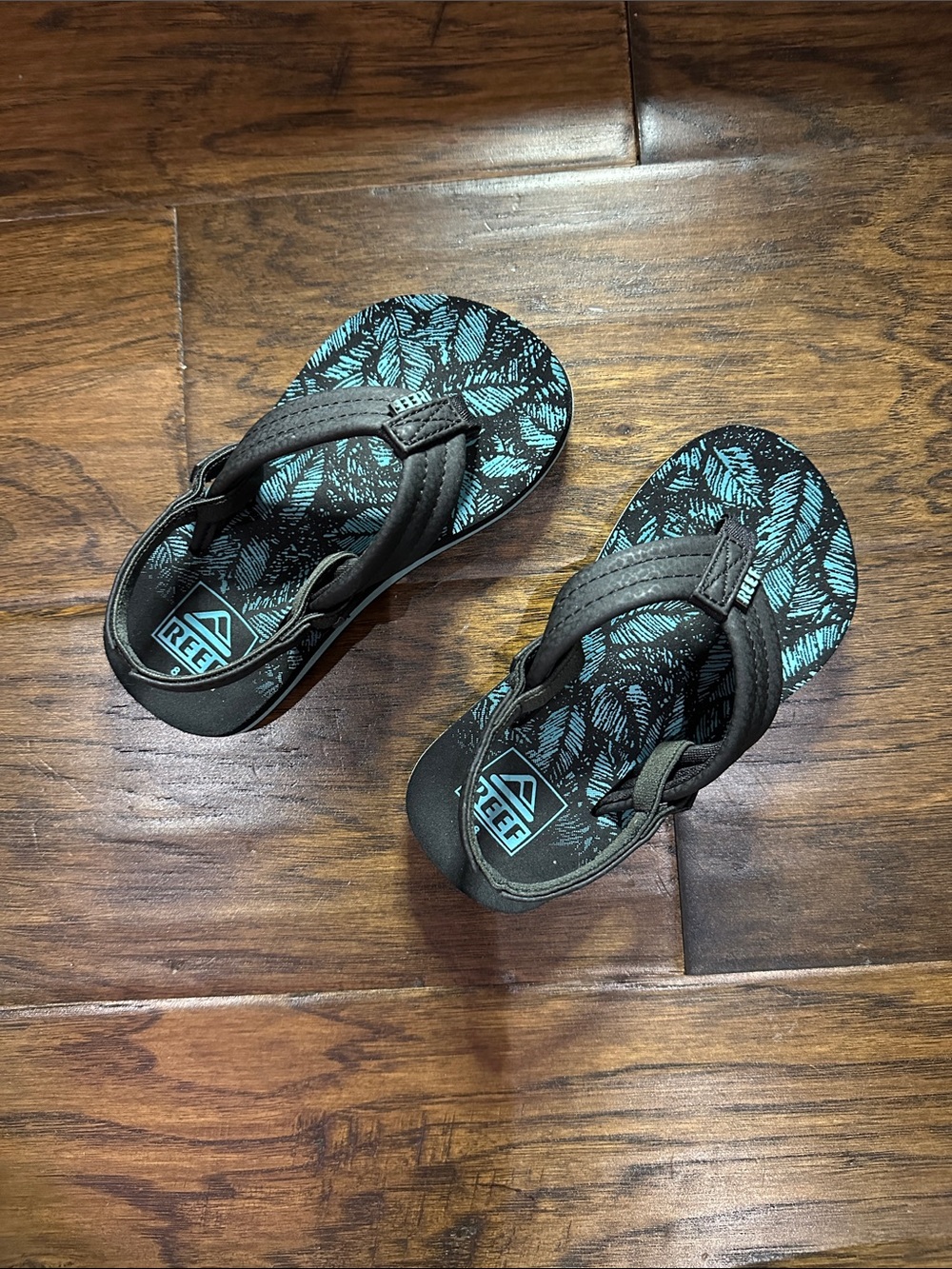 Reef Kids Teal Leaf Print Flip Flops with Black Straps